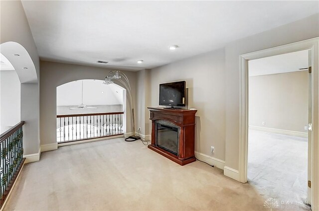 living room with ceiling fan and carpet flooring