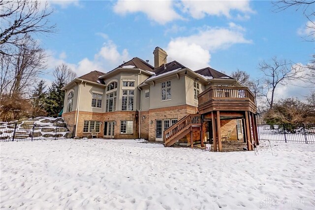 snow covered property featuring a deck