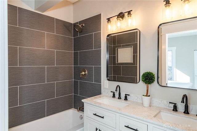 bathroom with vanity and tiled shower / bath