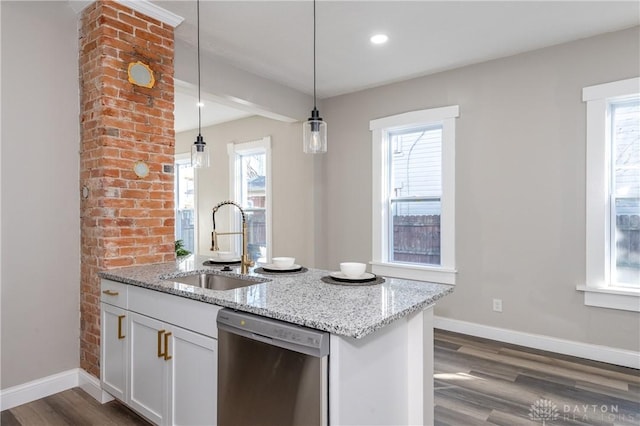 kitchen featuring light stone countertops, pendant lighting, white cabinets, sink, and stainless steel dishwasher