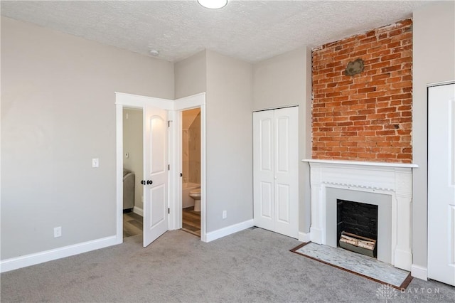 unfurnished living room with a textured ceiling and light carpet