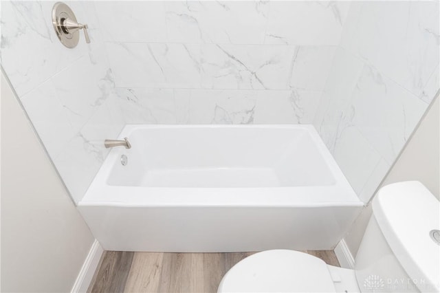 bathroom with hardwood / wood-style flooring and toilet