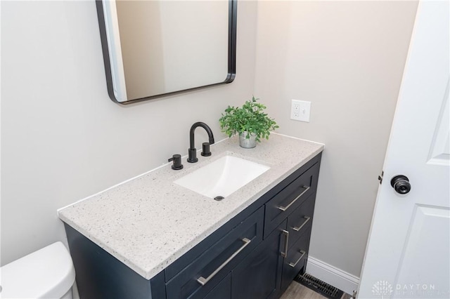 bathroom featuring toilet and vanity