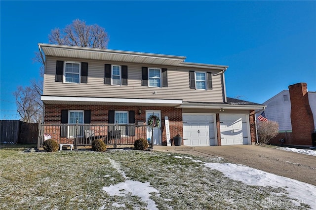 view of front of home featuring a garage, covered porch, and a front lawn