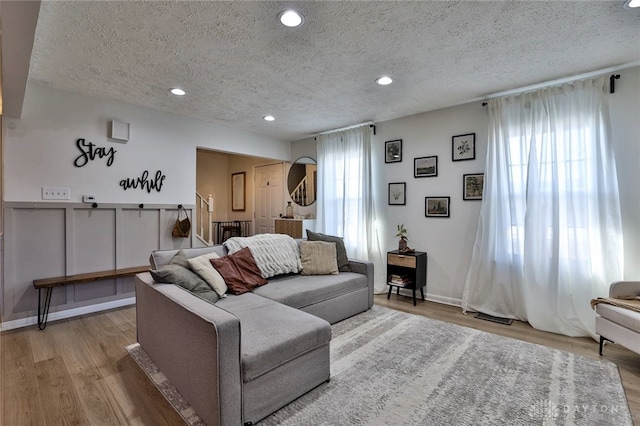 living room featuring a textured ceiling and light hardwood / wood-style flooring