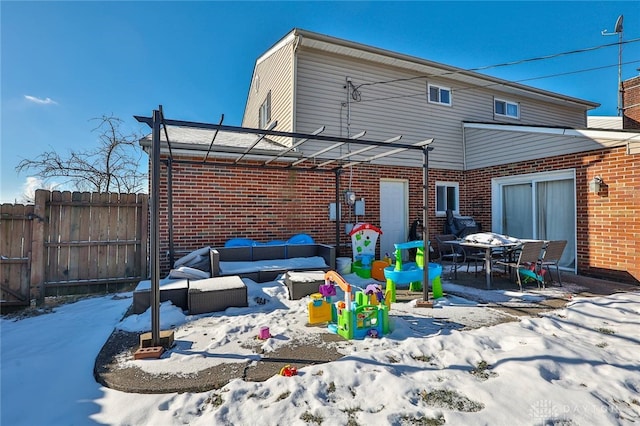 snow covered property featuring a pergola