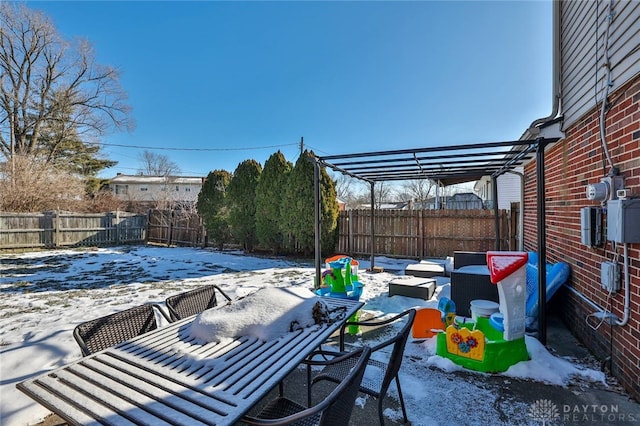 snow covered patio with a pergola