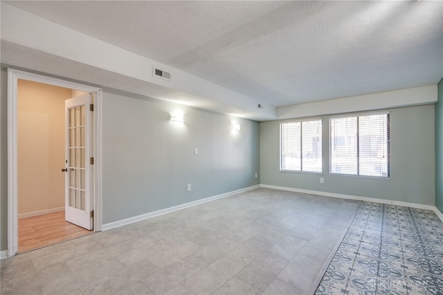 empty room with a textured ceiling