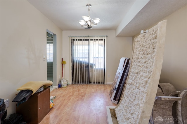 misc room with light hardwood / wood-style floors and a textured ceiling