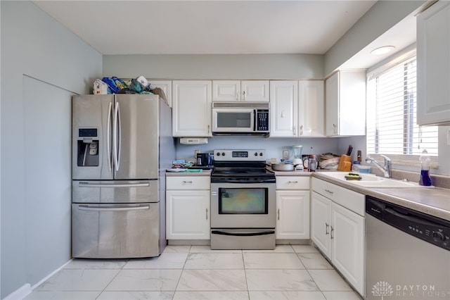 kitchen with sink, white cabinetry, and stainless steel appliances