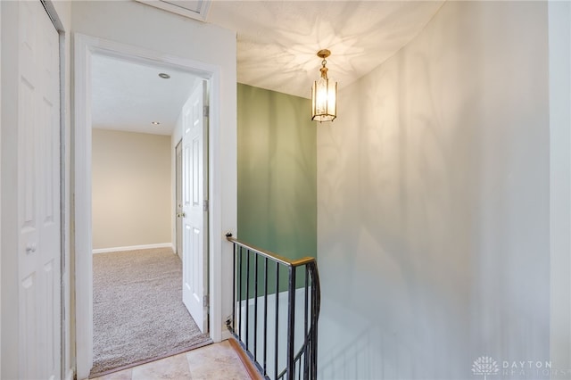 corridor featuring light colored carpet