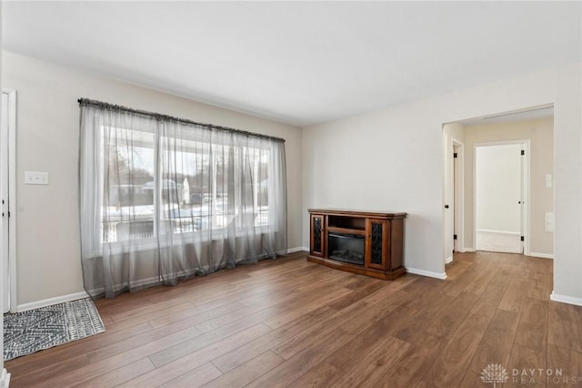 unfurnished living room featuring hardwood / wood-style flooring