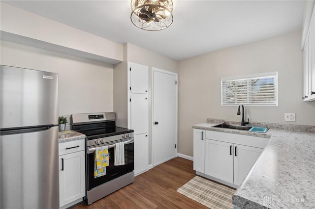 kitchen featuring white cabinetry, sink, light hardwood / wood-style flooring, and appliances with stainless steel finishes