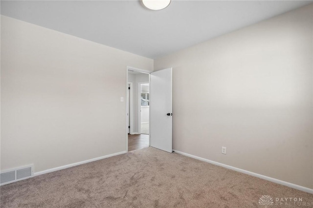 unfurnished room featuring carpet