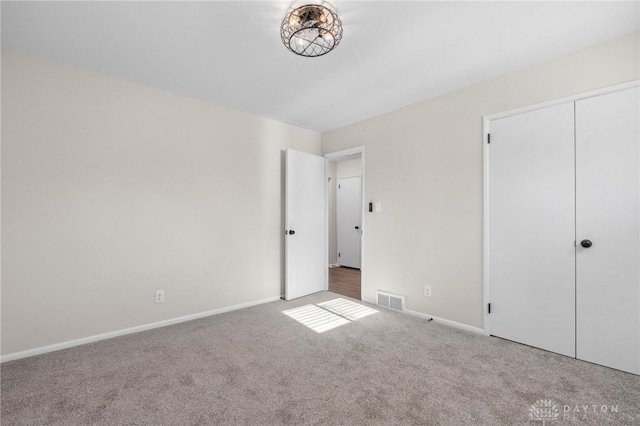 unfurnished bedroom featuring a closet and carpet