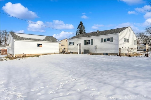 snow covered house with central air condition unit