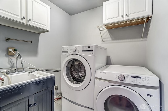 laundry area with cabinets, sink, and washing machine and clothes dryer