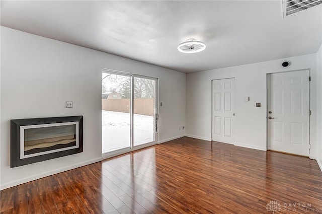 unfurnished living room featuring dark hardwood / wood-style flooring