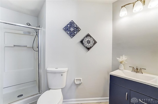 bathroom featuring toilet, vanity, and walk in shower