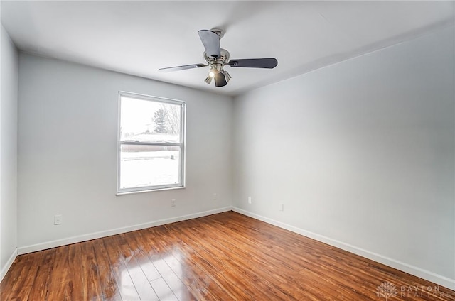 empty room with hardwood / wood-style floors and ceiling fan