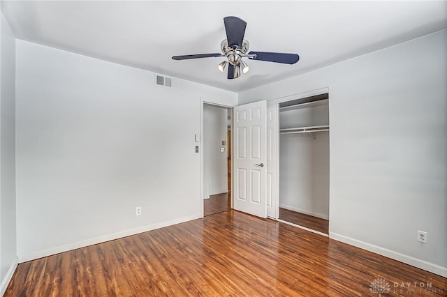 unfurnished bedroom with hardwood / wood-style flooring, a closet, and ceiling fan