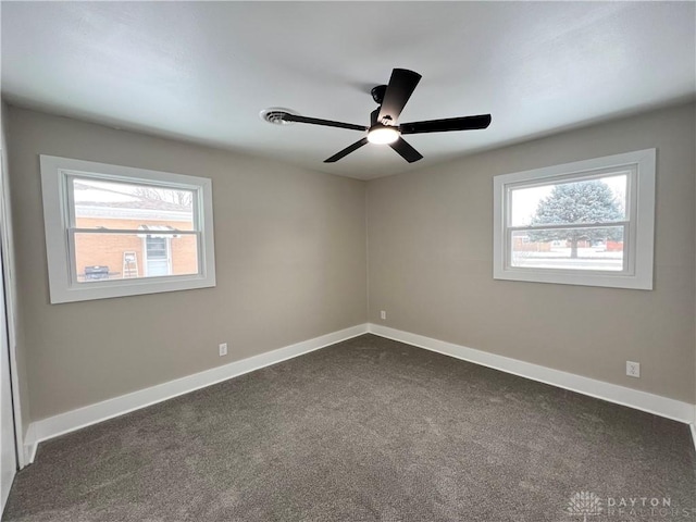 carpeted spare room featuring ceiling fan