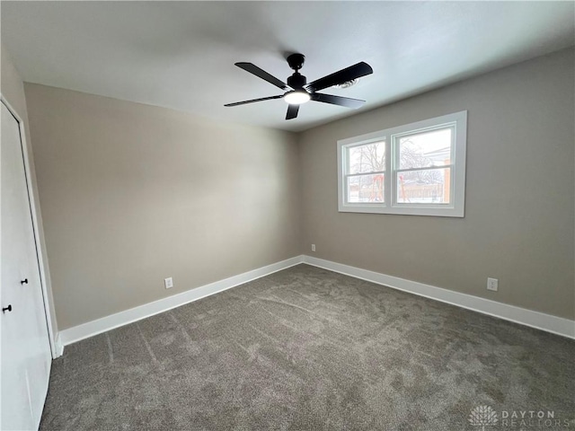 carpeted spare room with ceiling fan