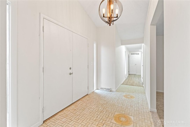 foyer entrance with a notable chandelier