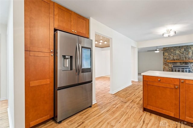 kitchen featuring light hardwood / wood-style floors, ceiling fan, and stainless steel refrigerator with ice dispenser