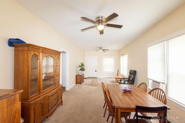 carpeted dining area with ceiling fan and plenty of natural light