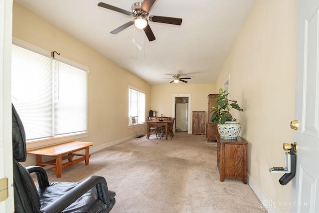 living area featuring ceiling fan and light carpet