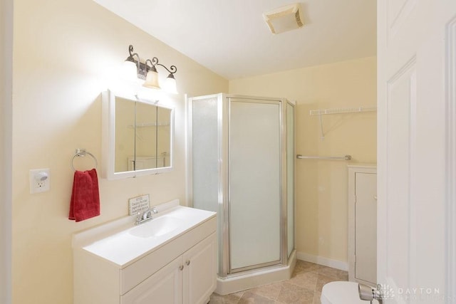 bathroom with toilet, walk in shower, and vanity