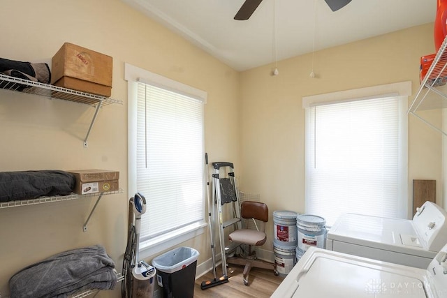 laundry room with light wood-type flooring, ceiling fan, and separate washer and dryer