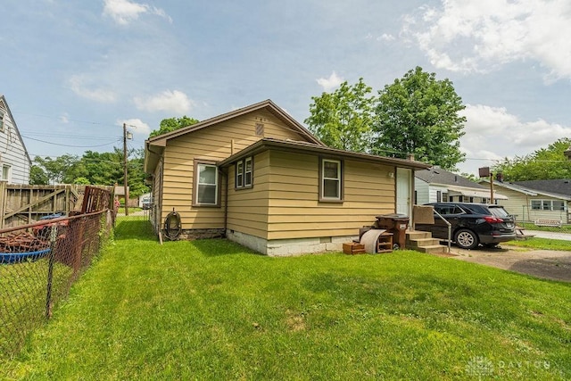 rear view of property featuring a yard