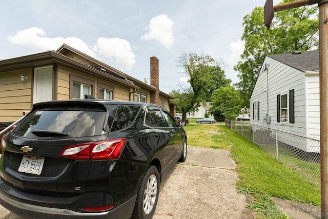 view of side of home featuring a lawn