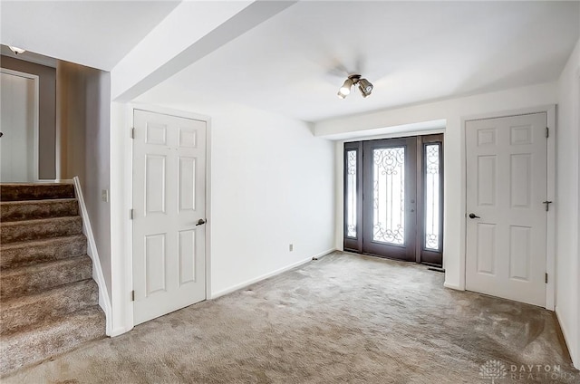 view of carpeted foyer entrance