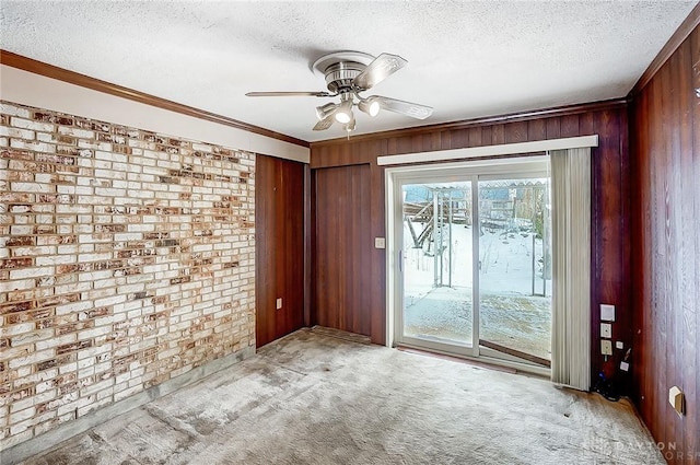 unfurnished room featuring light carpet, a textured ceiling, and wood walls