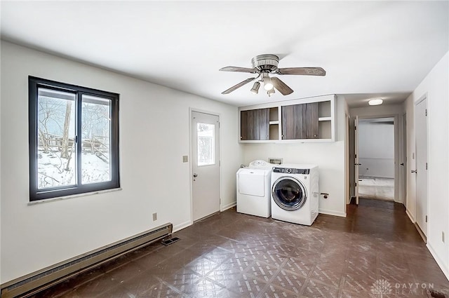 clothes washing area with cabinets, a baseboard radiator, washer and dryer, and ceiling fan