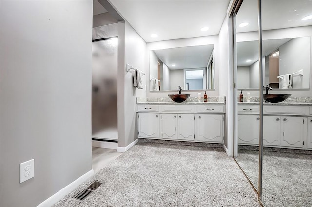 bathroom with vanity and walk in shower