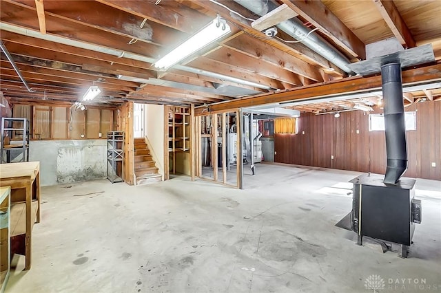 basement featuring wood walls