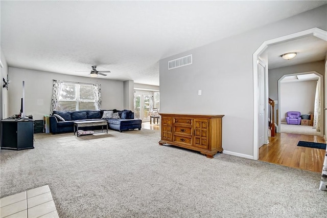 living room with carpet flooring and ceiling fan