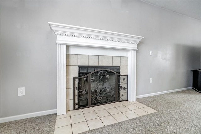 room details with a tiled fireplace and carpet floors