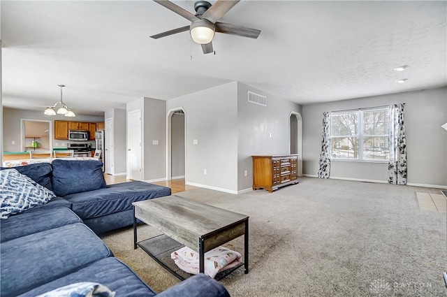 carpeted living room featuring ceiling fan