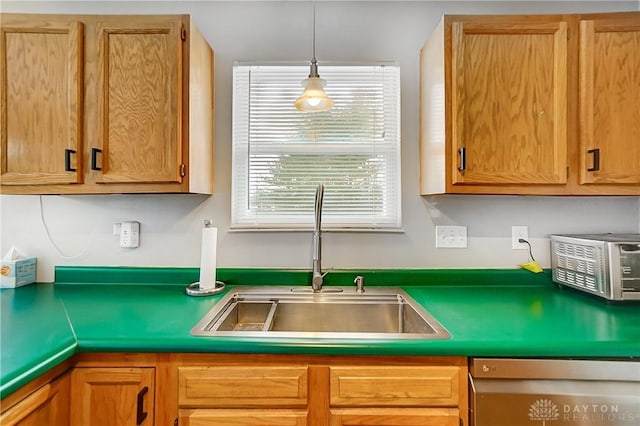 kitchen with plenty of natural light, sink, pendant lighting, and dishwashing machine