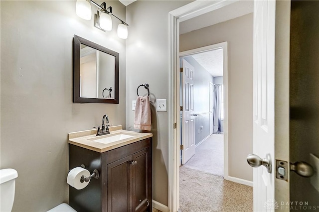 bathroom featuring vanity, a textured ceiling, and toilet