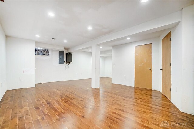 basement with hardwood / wood-style floors