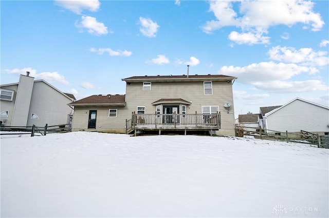 snow covered property with a wooden deck