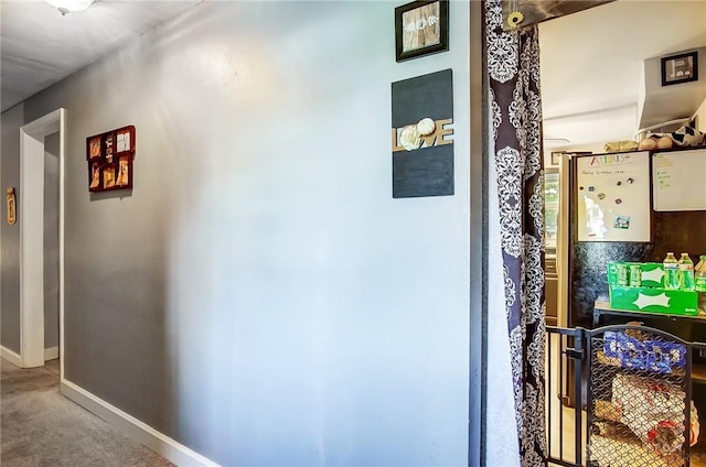 corridor with carpet floors and baseboards