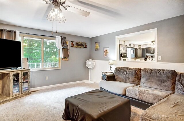 living room with ceiling fan and light colored carpet