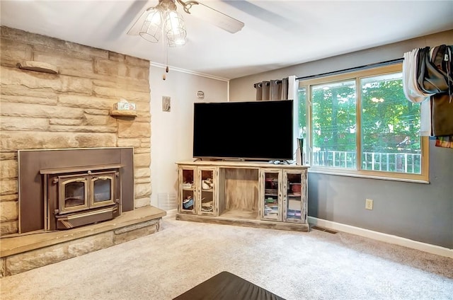 unfurnished living room featuring carpet floors, baseboards, and a ceiling fan